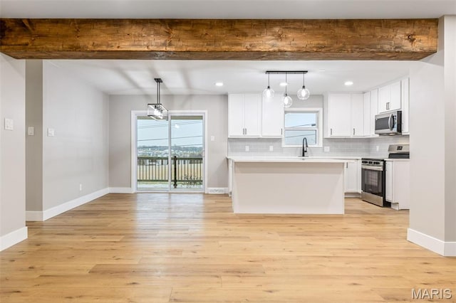 1121 E Cap Au Gris St, Troy, MO 63379 - kitchen featuring stainless steel appliances, a sink, beam ceiling, white cabinets, and tasteful backsplash