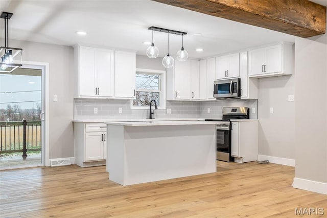1121 E Cap Au Gris St, Troy, MO 63379 - kitchen with stainless steel appliances, baseboards, white cabinetry, and recessed lighting