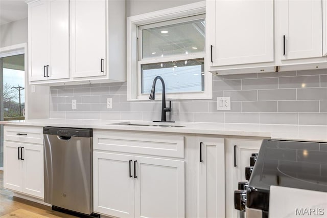 1121 E Cap Au Gris St, Troy, MO 63379 - kitchen featuring stainless steel dishwasher, a sink, light countertops, white cabinetry, and decorative backsplash