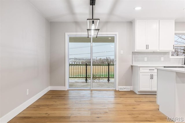 1121 E Cap Au Gris St, Troy, MO 63379 - kitchen featuring light countertops, white cabinetry, baseboards, tasteful backsplash, and recessed lighting