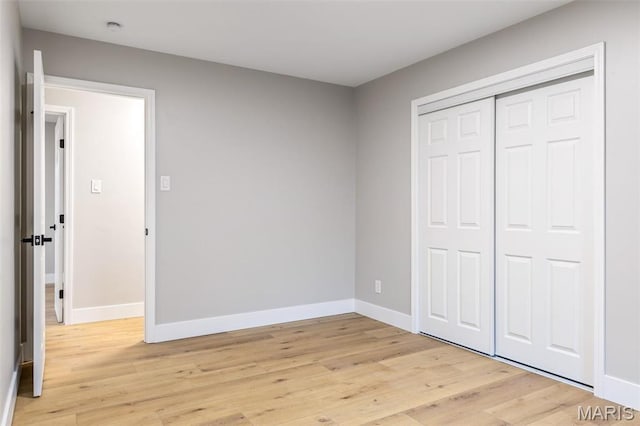 1121 E Cap Au Gris St, Troy, MO 63379 - unfurnished bedroom with baseboards, light wood finished floors, and a closet
