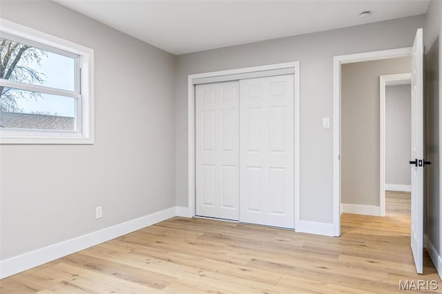 1121 E Cap Au Gris St, Troy, MO 63379 - unfurnished bedroom with baseboards, a closet, and light wood-style flooring