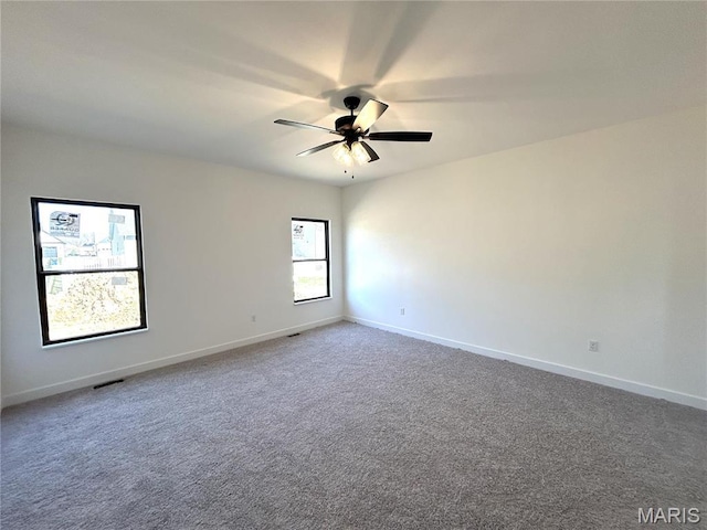 unfurnished room with a ceiling fan, carpet flooring, and baseboards