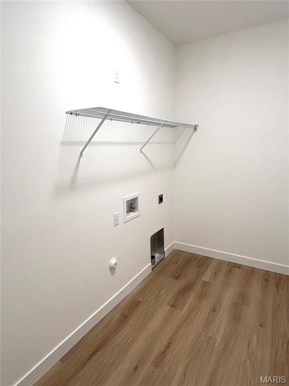laundry room featuring hookup for a washing machine, wood finished floors, baseboards, and electric dryer hookup