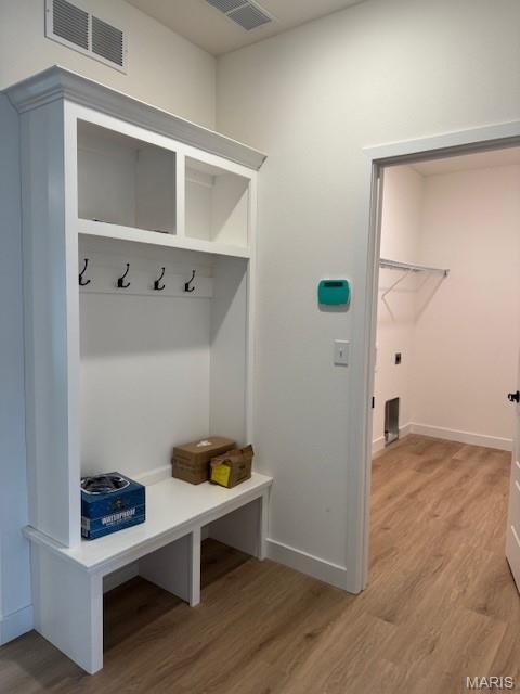 mudroom featuring light wood-style floors and baseboards
