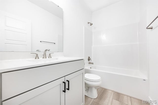 full bathroom featuring toilet, vanity, and tub / shower combination