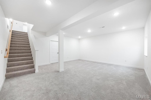 finished basement with carpet floors, recessed lighting, stairway, and baseboards