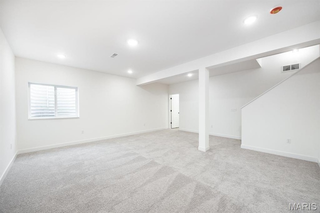 basement featuring recessed lighting, light carpet, and baseboards