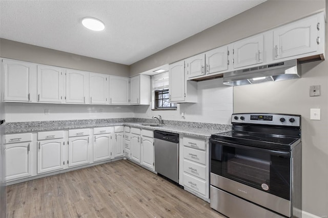 1680 Neff Rd, Saint Clair, MO 63077 - kitchen with appliances with stainless steel finishes, under cabinet range hood, white cabinets, light wood finished floors, and a textured ceiling