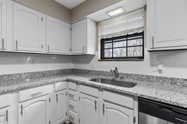 1680 Neff Rd, Saint Clair, MO 63077 - kitchen featuring dishwasher, a sink, white cabinets, tasteful backsplash, and light stone counters