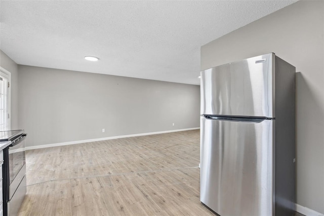 1680 Neff Rd, Saint Clair, MO 63077 - kitchen featuring freestanding refrigerator, light wood-style flooring, baseboards, a textured ceiling, and recessed lighting