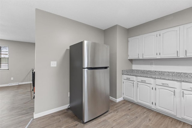 1680 Neff Rd, Saint Clair, MO 63077 - kitchen featuring freestanding refrigerator, white cabinetry, baseboards, and light wood-style flooring