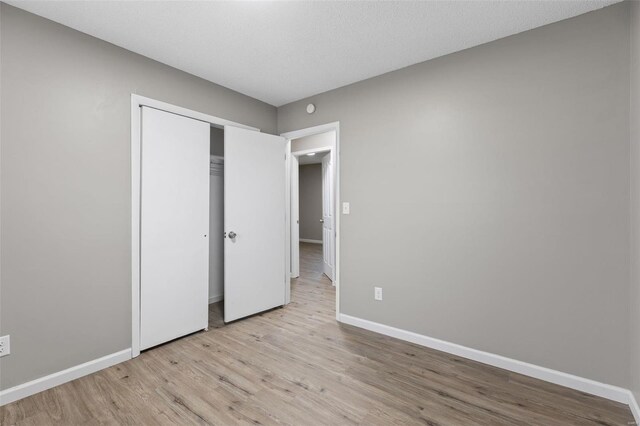 1680 Neff Rd, Saint Clair, MO 63077 - unfurnished bedroom featuring light wood-style flooring, baseboards, and a closet