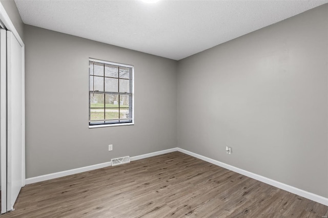 1680 Neff Rd, Saint Clair, MO 63077 - empty room with wood finished floors, baseboards, and a textured ceiling