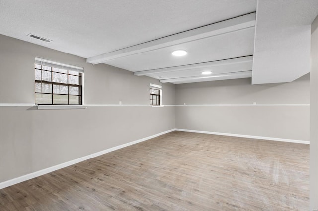 1680 Neff Rd, Saint Clair, MO 63077 - basement with wood finished floors, baseboards, plenty of natural light, recessed lighting, and a textured ceiling
