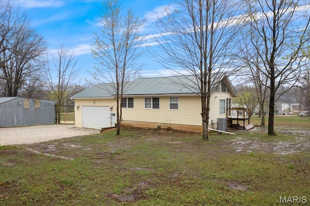 34441 Hickory Hills Rd, Mo, MO 65078 - view of side of property with gravel driveway, a garage, central AC, and metal roof