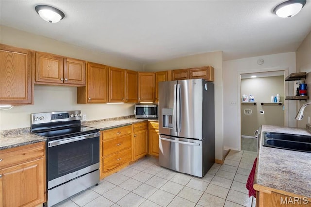34441 Hickory Hills Rd, Mo, MO 65078 - kitchen with appliances with stainless steel finishes, a sink, light tile patterned floors, and light countertops