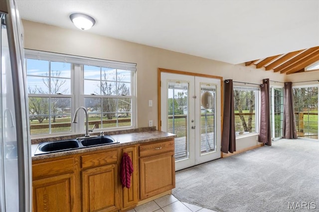 34441 Hickory Hills Rd, Mo, MO 65078 - kitchen featuring a sink, french doors, brown cabinets, freestanding refrigerator, and healthy amount of natural light