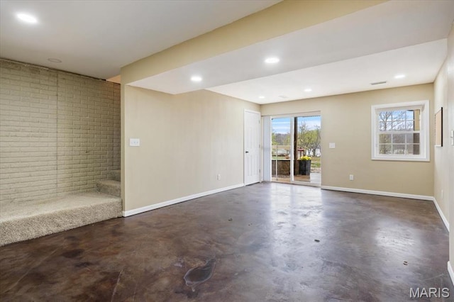 34441 Hickory Hills Rd, Mo, MO 65078 - empty room with finished concrete flooring, plenty of natural light, baseboards, recessed lighting, and brick wall