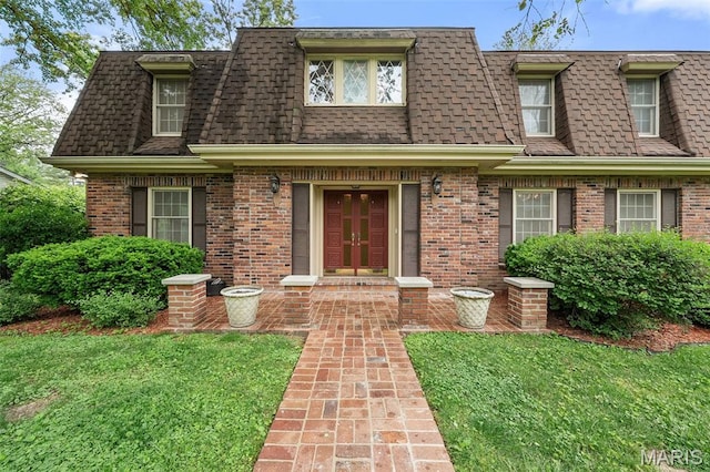 10221 Lylewood Dr, Ladue, MO 63124 - view of front of house with roof with shingles, mansard roof, brick siding, and a front lawn
