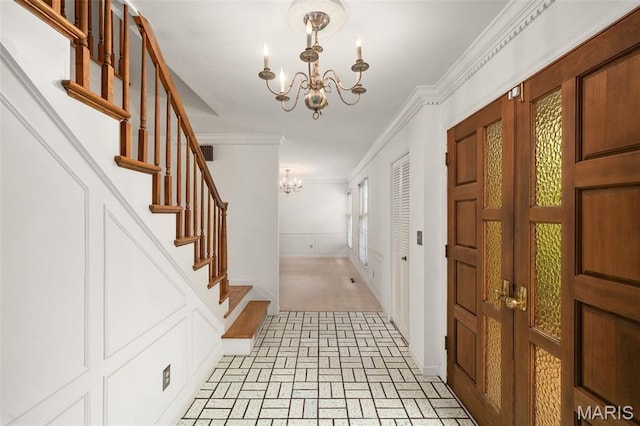 10221 Lylewood Dr, Ladue, MO 63124 - foyer featuring a chandelier, brick patterned floors, ornamental molding, and stairway