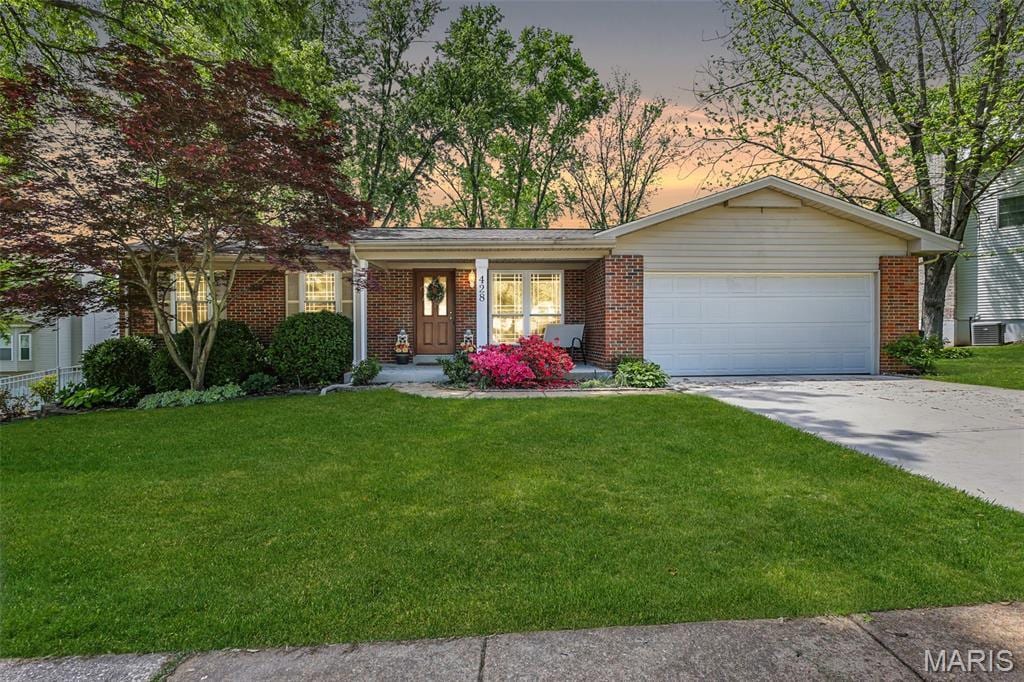 428 Melanie Meadows Ln, Ballwin, MO 63021 - single story home with an attached garage, a front lawn, driveway, and brick siding