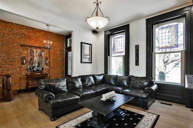 910 Lami St, Saint Louis, MO 63104 - living area featuring brick wall and wood finished floors