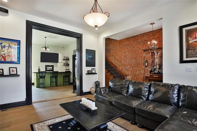 910 Lami St, Saint Louis, MO 63104 - living room featuring wood finished floors, stairs, and brick wall