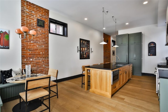 910 Lami St, Saint Louis, MO 63104 - kitchen with a sink, light wood-style floors, baseboards, recessed lighting, and appliances with stainless steel finishes