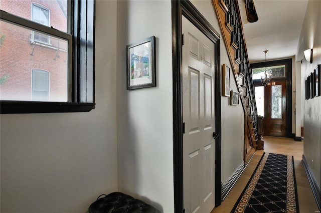 910 Lami St, Saint Louis, MO 63104 - hallway featuring wood finished floors, baseboards, and stairs