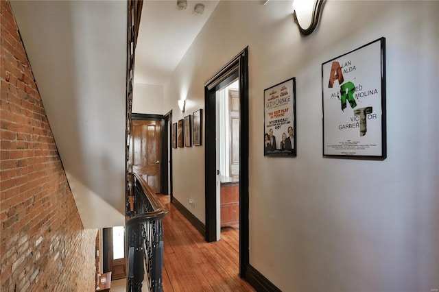 910 Lami St, Saint Louis, MO 63104 - hallway with wood-type flooring, baseboards, and brick wall