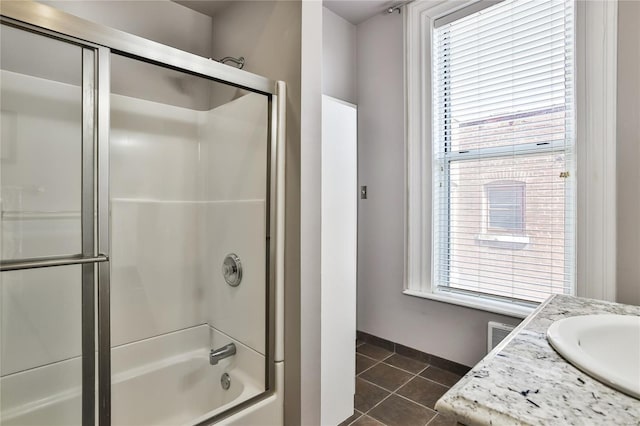 910 Lami St, Saint Louis, MO 63104 - bathroom featuring tile patterned floors, baseboards, shower / bath combination with glass door, and vanity