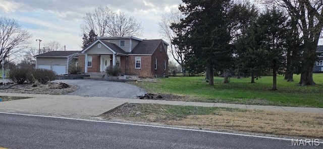 2520 Charbonier Rd, Florissant, MO 63031 - view of front of house with a front yard, asphalt driveway, a garage, and brick siding