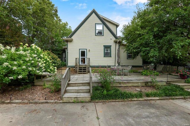 312 Bellevue St, Cape Girardeau, MO 63701 - rear view of house featuring a wooden deck and outdoor dining space