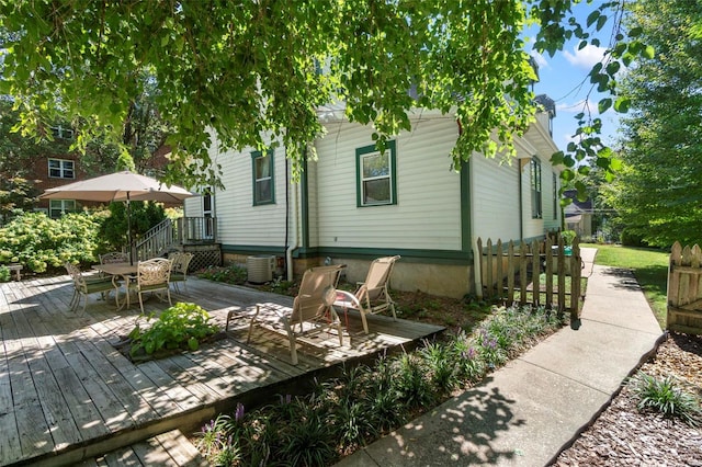 312 Bellevue St, Cape Girardeau, MO 63701 - rear view of house featuring a deck, outdoor dining area, fence, and central air condition unit