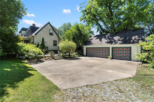 312 Bellevue St, Cape Girardeau, MO 63701 - view of side of home featuring a lawn, a chimney, and a detached garage