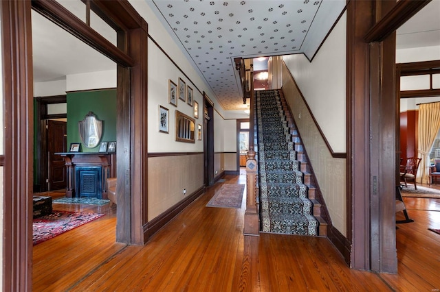 312 Bellevue St, Cape Girardeau, MO 63701 - staircase with a wainscoted wall, hardwood / wood-style floors, and wallpapered walls