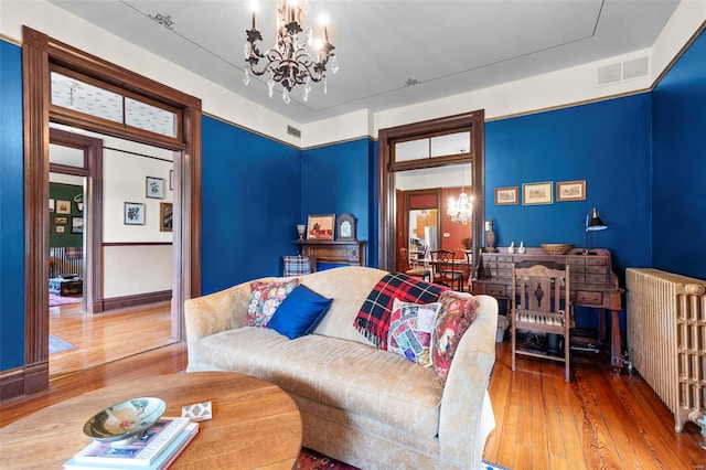 312 Bellevue St, Cape Girardeau, MO 63701 - bedroom featuring radiator, a chandelier, and hardwood / wood-style floors
