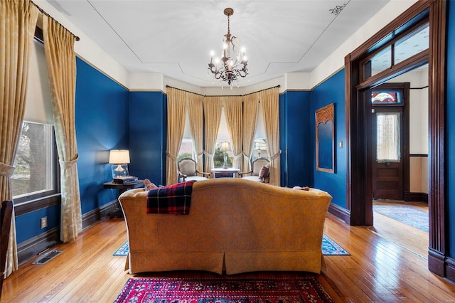 312 Bellevue St, Cape Girardeau, MO 63701 - living room featuring a chandelier, hardwood / wood-style floors, and baseboards