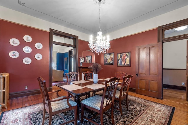 312 Bellevue St, Cape Girardeau, MO 63701 - dining space with hardwood / wood-style flooring, baseboards, and a chandelier