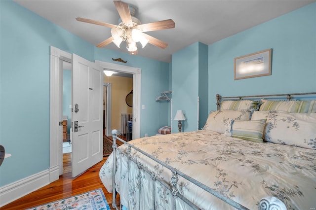 312 Bellevue St, Cape Girardeau, MO 63701 - bedroom with light wood-style floors, a ceiling fan, radiator heating unit, and baseboards