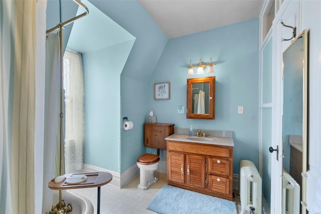 312 Bellevue St, Cape Girardeau, MO 63701 - full bathroom featuring baseboards, radiator, toilet, vanity, and lofted ceiling