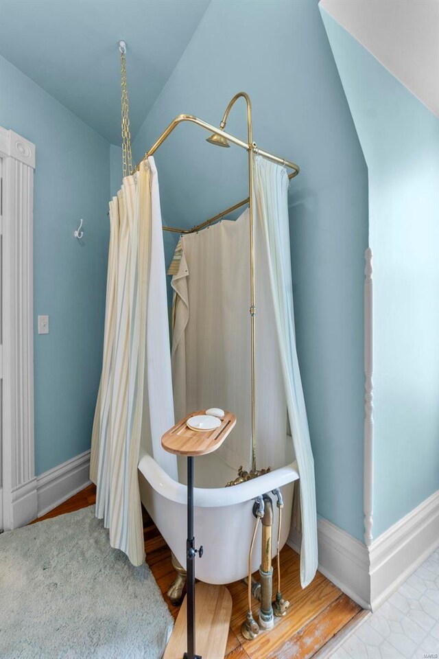 312 Bellevue St, Cape Girardeau, MO 63701 - full bath with a freestanding bath, baseboards, wood finished floors, and a shower with shower curtain