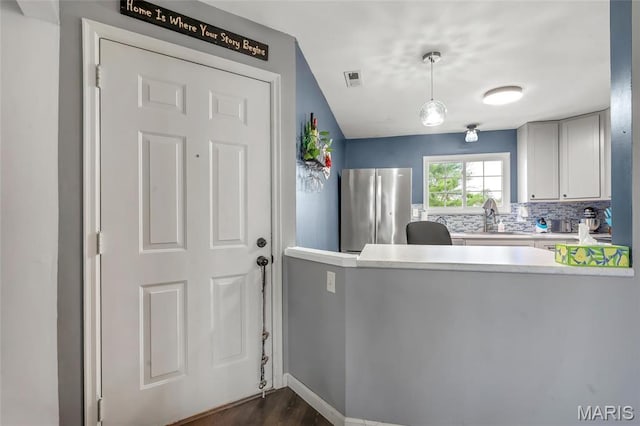 745 Sugar Glen Dr Unit 5, Saint Peters, MO 63376 - kitchen featuring freestanding refrigerator, dark wood-style floors, light countertops, a sink, and a peninsula