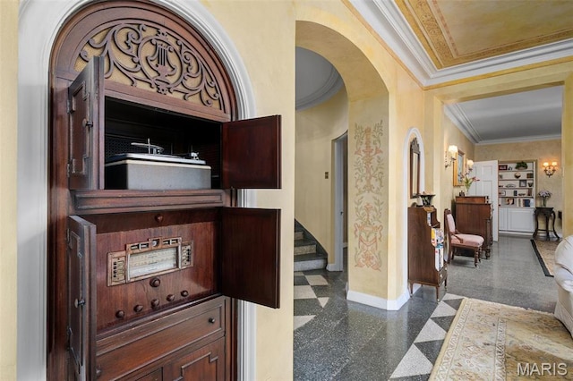 8 Carrswold Dr, Clayton, MO 63105 - entrance foyer featuring baseboards, arched walkways, and ornamental molding
