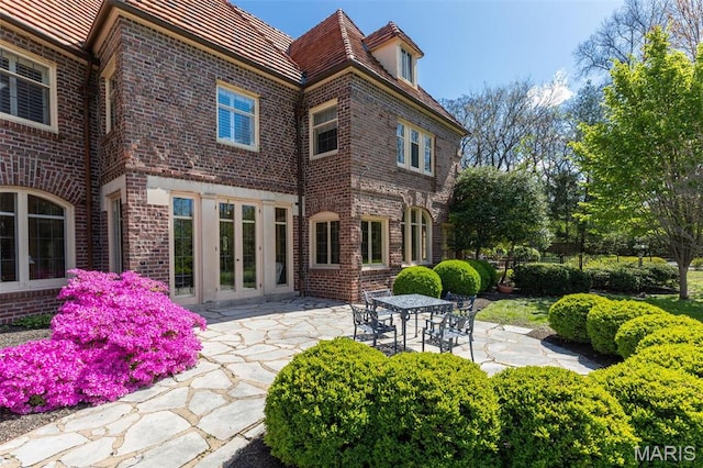 8 Carrswold Dr, Clayton, MO 63105 - back of house featuring brick siding, a patio, and french doors