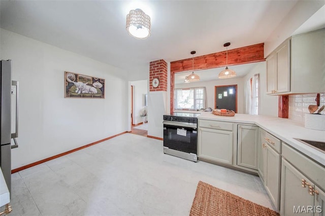 1003 S Warfel St, Salem, MO 65560 - kitchen with electric range, decorative light fixtures, light countertops, baseboards, and a peninsula