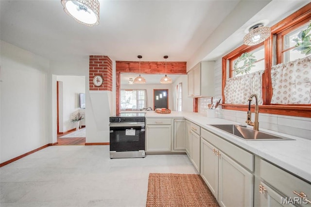 1003 S Warfel St, Salem, MO 65560 - kitchen with a sink, electric stove, light countertops, tasteful backsplash, and decorative light fixtures