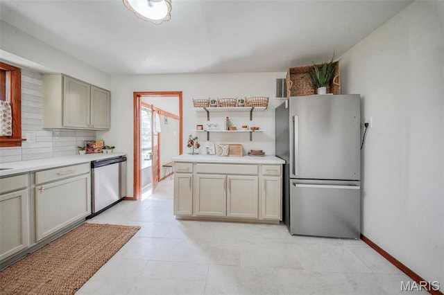 1003 S Warfel St, Salem, MO 65560 - kitchen with stainless steel appliances, light countertops, open shelves, and light tile patterned flooring