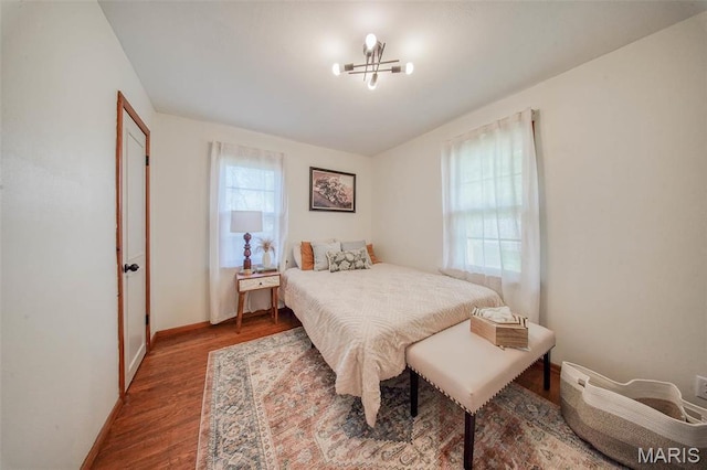 1003 S Warfel St, Salem, MO 65560 - bedroom with wood finished floors, baseboards, and a chandelier